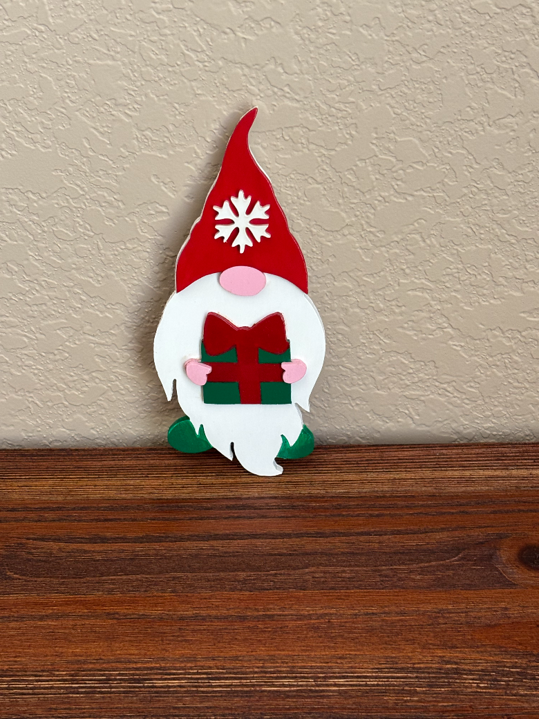 Decorative gnome wall hanging on a neutral wall and wooden surface