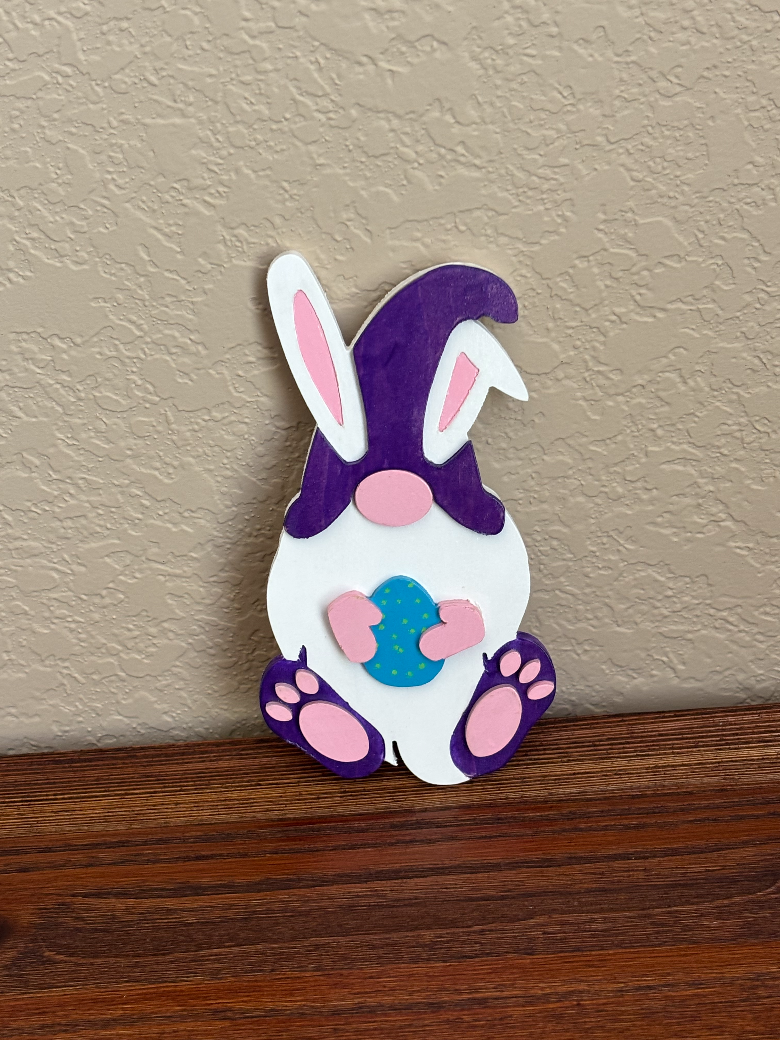 Decorative door magnet shaped like a cartoon cat with bunny ears on a textured wall.