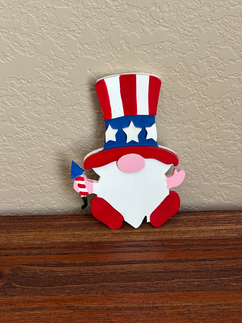 Decorative gnome with American flag hat on a wooden surface