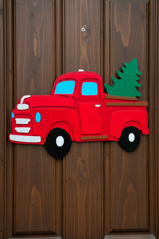 Red truck-shaped door decoration on a beige garage door